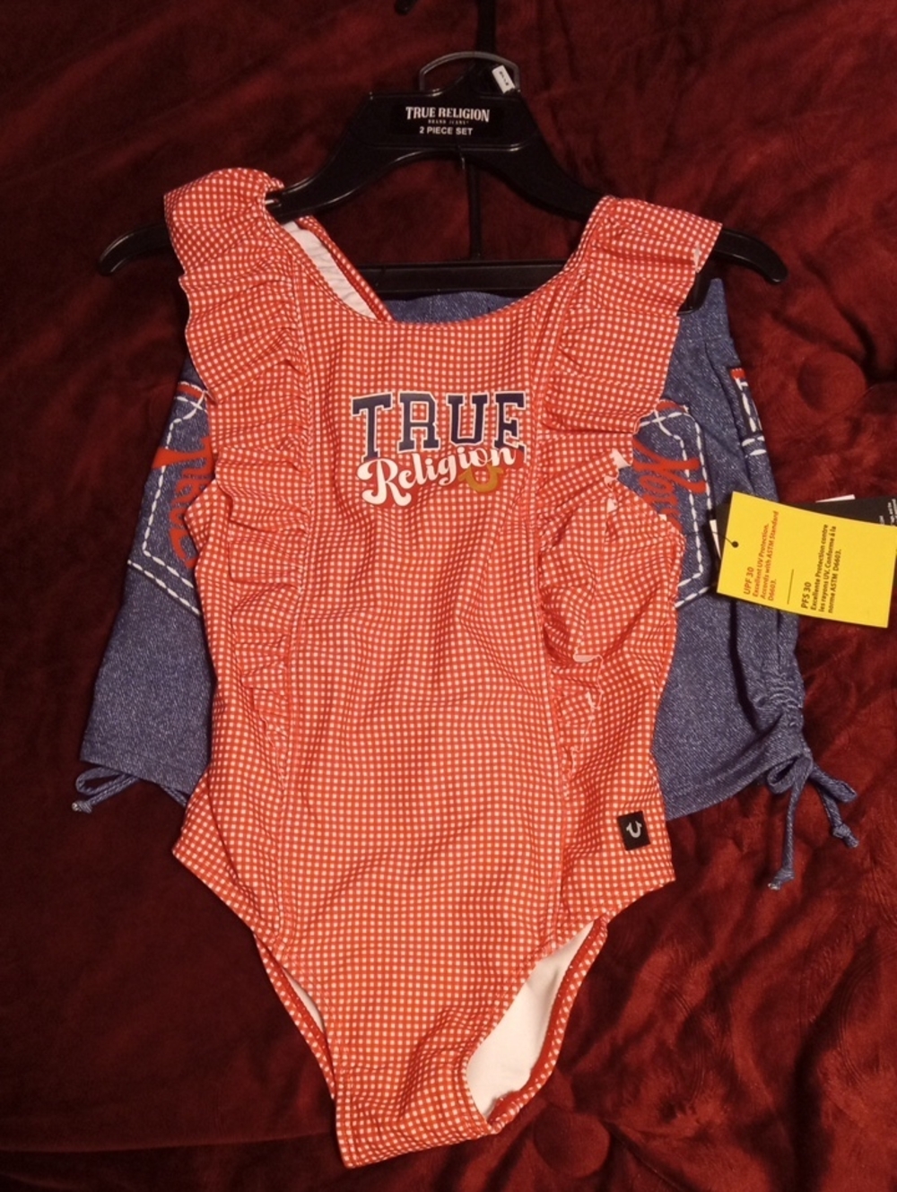 True Religion red and white Gingham Ruffle-Shoulder Bodysuit and swim shorts.